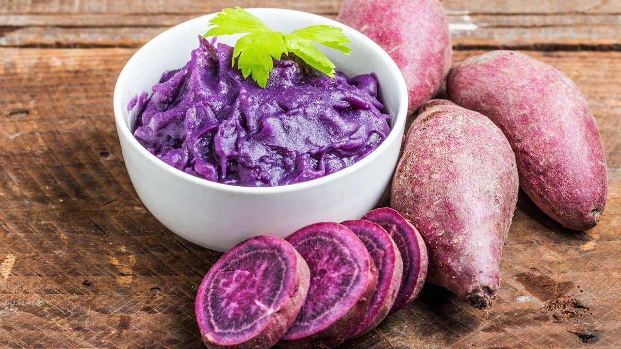 Whole and sliced ube purple yam showing its deep violet color