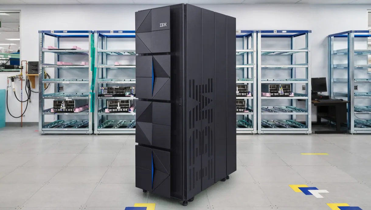 A modern, tall IBM Z-Series mainframe unit standing in a highly controlled, climate-regulated data center environment.